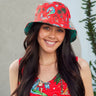 a green Christmas bucket hat with a picture of a man on a surfboard